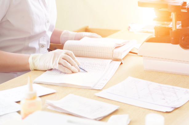 Health workers reviewing a maternal death case file during a facility-based death review meeting in the Philippines